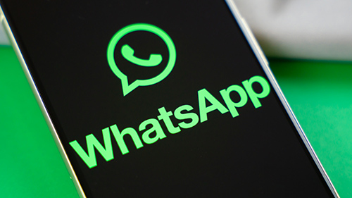 WhatsApp logo on smartphone next to everyday accessories Stock photo 2 - مدونة التقنية العربية